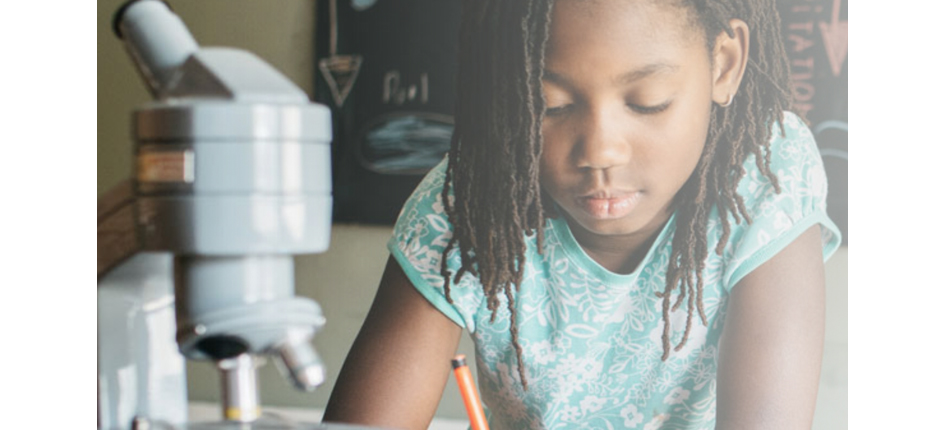 Young girl writing at a table.