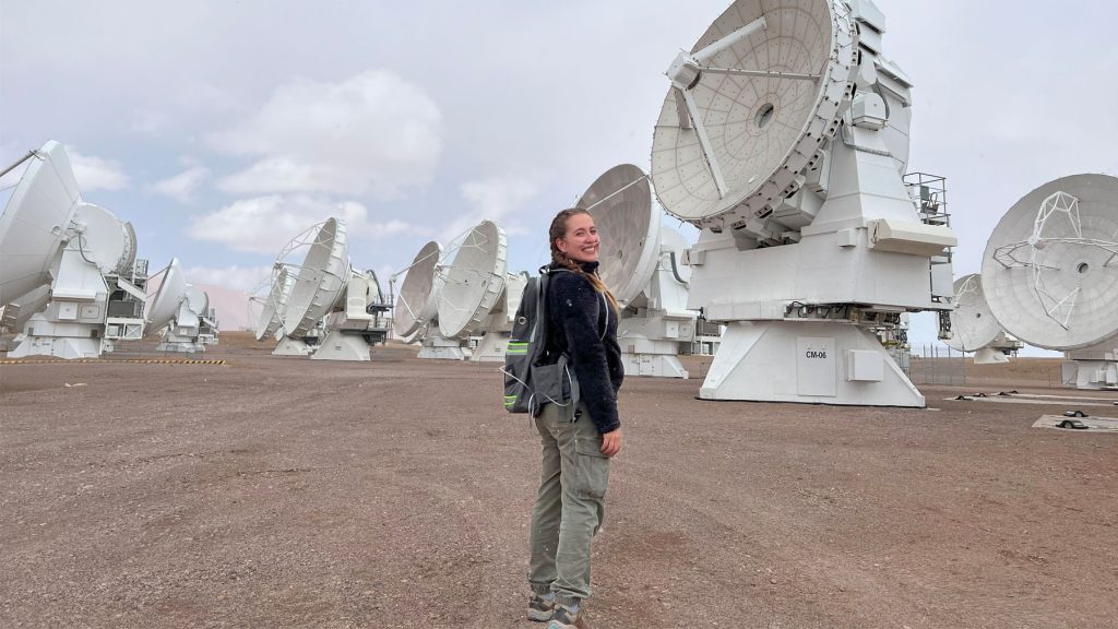 Teresa Paneque-Carreño in the field, smiling back at camera.