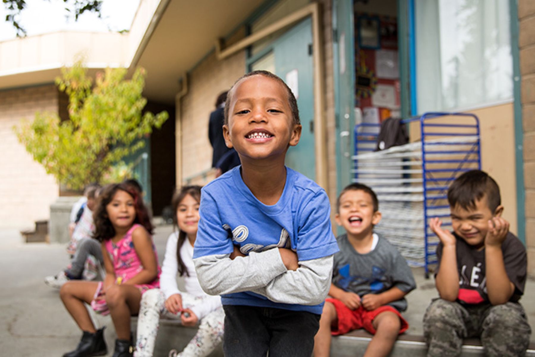 Five young children smiling at the camera.