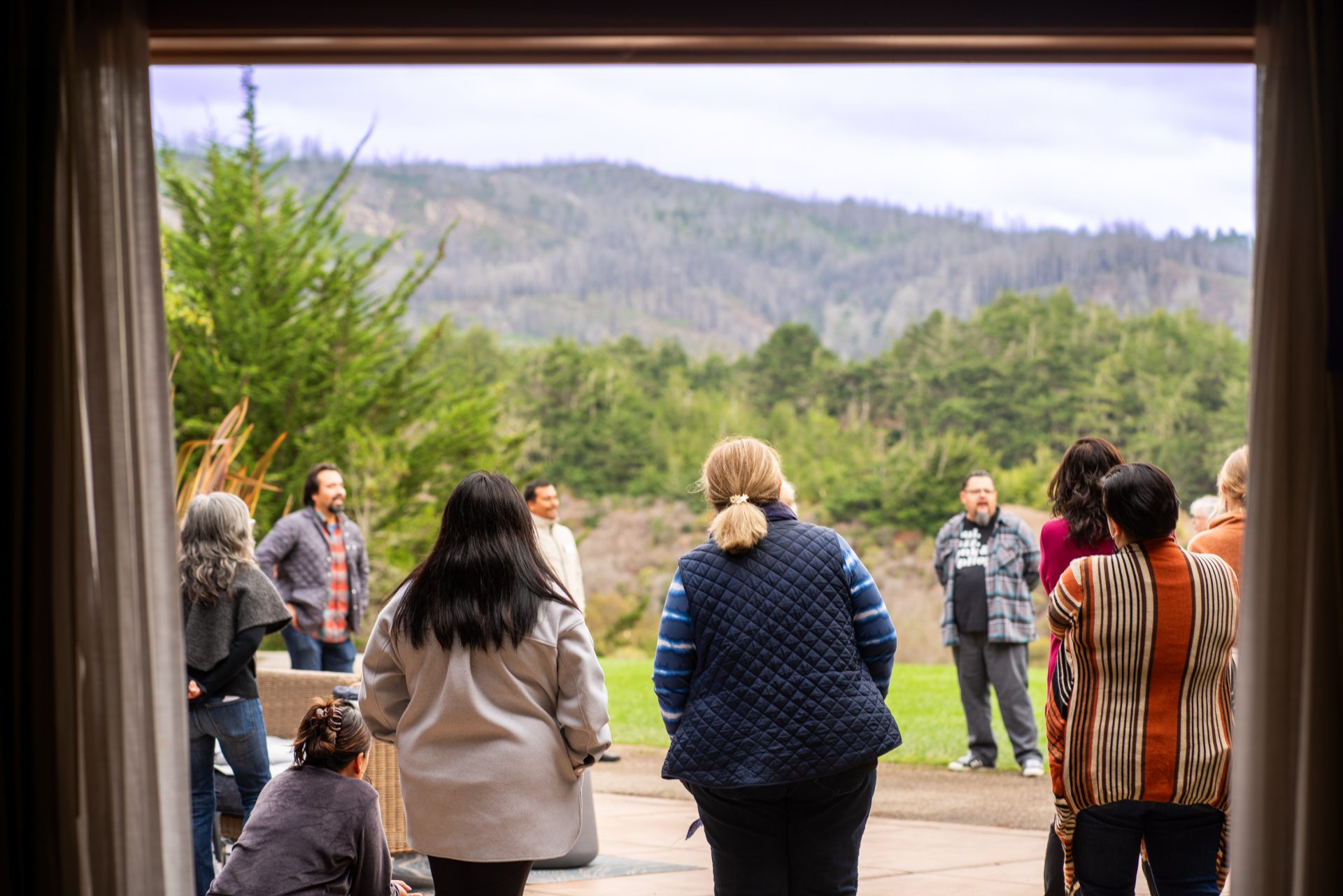 Group stands outside in a circle.